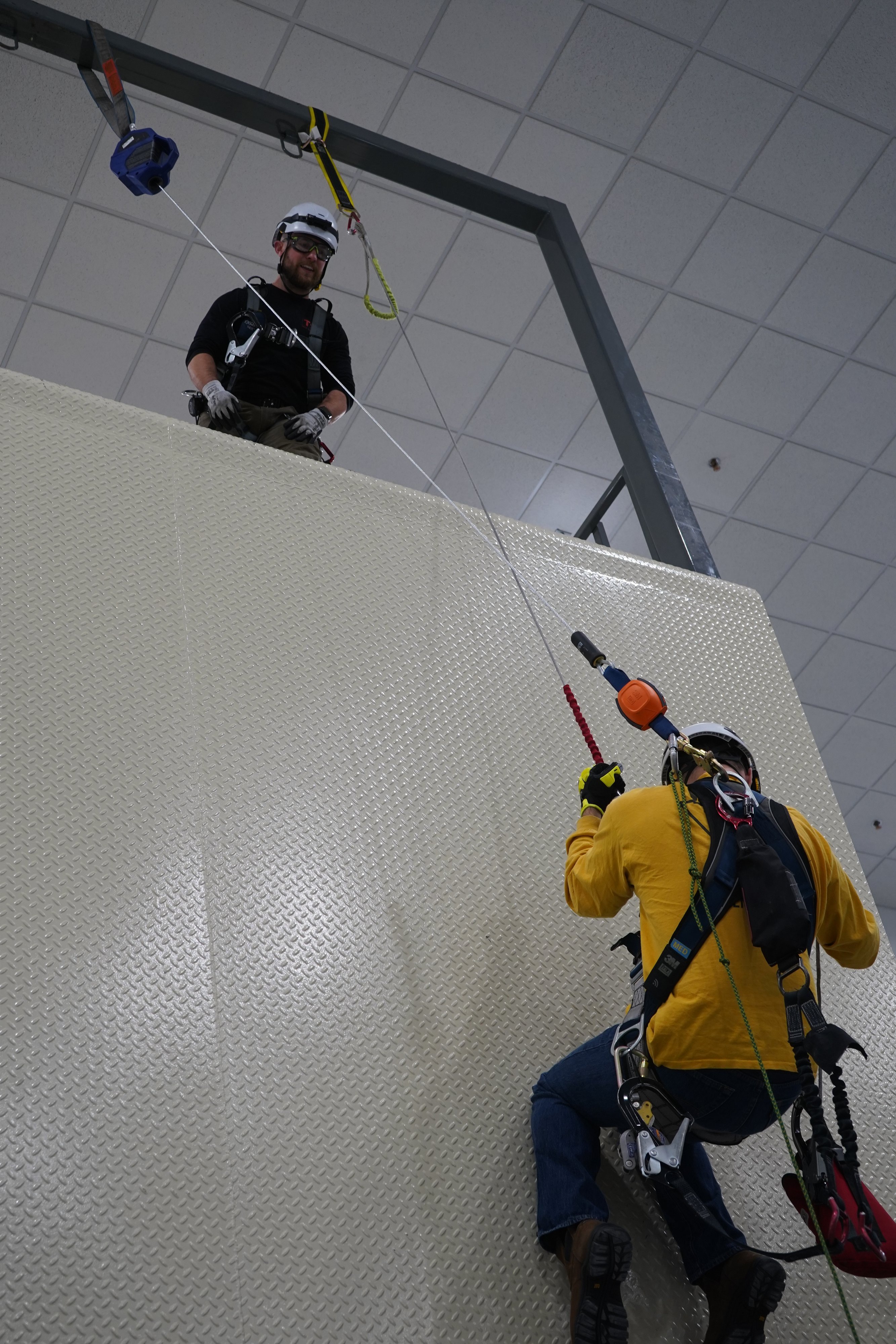 trainees repelling off wall